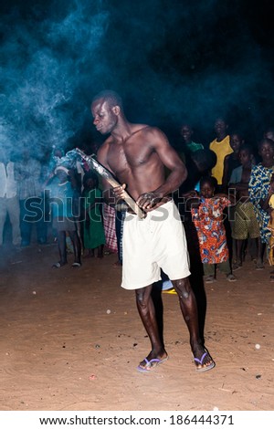 LOME, TOGO - MAR 7, 2012: Unidentified Togolese man eats fire for the fire show performance. People in Togo suffer of poverty due to a difficult economical situation