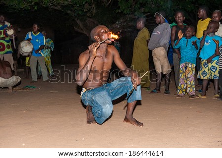 LOME, TOGO - MAR 7, 2012: unidentified Togolese man eats fire for the fire show performance. People in Togo suffer of poverty due to a difficult economical situation