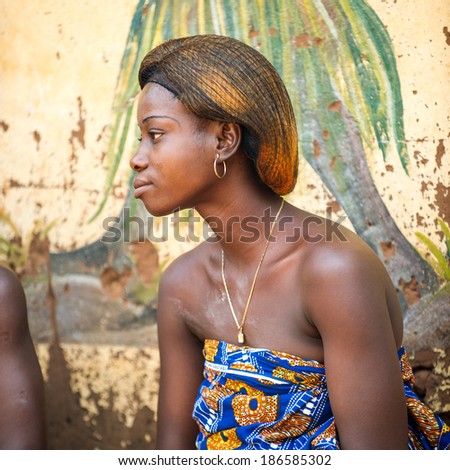KARA, TOGO - MAR 11, 2012:  Unidentified Togolese woman watches the religious voodoo dance. Voodoo is the West African religion