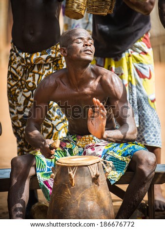 KARA, TOGO - MAR 11, 2012:  Unidentified Togolese drummer makes music for the religious voodoo dance performance. Voodoo is the West African religion