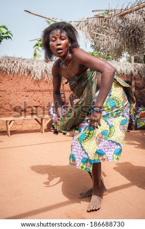 KARA, TOGO - MAR 11, 2012:  Unidentified Togolese woman in a traditional dress dances the religious voodoo dance. Voodoo is the West African religion