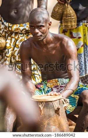 KARA, TOGO - MAR 11, 2012:  Unidentified Togolese drummer makes music for the religious voodoo dance performance. Voodoo is the West African religion