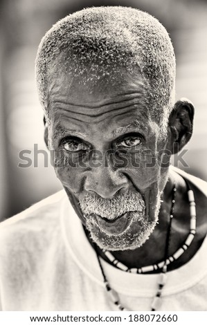 ACCRA, GHANA - MAR 3, 2012: Unidentified Ghanaian boy with a white beard and funny face. People of Ghana suffer of poverty due to the difficult economic situation