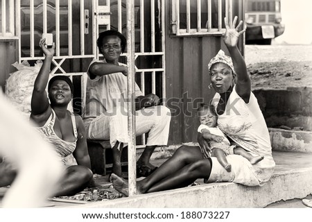 ACCRA, GHANA - MAR 2, 2012: Unidentified Ghanaian women in the street don't like to be on the photo. People of Ghana suffer of povert due to the difficult economic situation