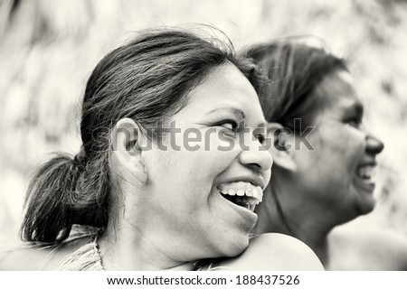 AMAZONIA, PERU - NOV 10, 2010: Unidentified Amazonian indigenous two women laugh. Indigenous people of Amazonia are protected by COICA Coordinator of Indigenous Organizations of the Amazon River Basin