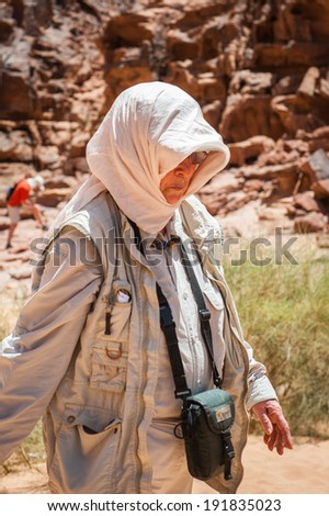 WADI RUM, JORDAN - APR 30, 2014: Unidentified tourist walks in the Wadi Rum valley. Wadi Rum valley is the UNESCO World Heritage site