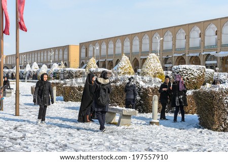 ISFAHAN, IRAN - JAN 7, 2014: Unidentified Iranian girls on the Naghsh-i Jahan Square. Naghsh-i Jahan Square is a UNESCO World Heritage