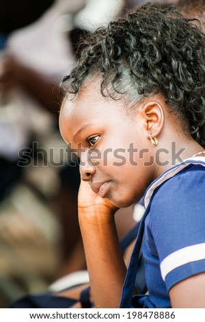 ACCRA, GHANA - MARCH 4, 2012: Unidentified Ghanaian student watch the  local street show in Ghana. Children of Ghana suffer of poverty due to the unstable economic situation