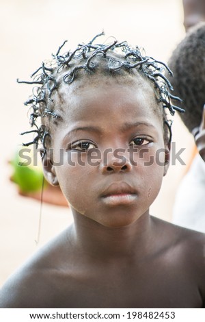 ACCRA, GHANA - MARCH 6, 2012: Unidentified Ghanaian beautiful boy with a nice haircut in the street in Ghana. Children of Ghana suffer of poverty due to the unstable economic situation