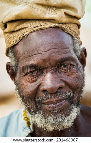 ACCRA, GHANA - MARCH 6, 2012: Unidentified Ghanaian old man with a hat in the street in Ghana. People of Ghana suffer of poverty due to the unstable economic situation