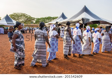 ACCRA, GHANA - MARCH 4, 2012: Unidentified Ghanaian people walk to see a music show in the street in Ghana. People of Ghana suffer of poverty due to the unstable economic situation