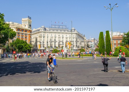 MADRID, SPAIN - JUN 19, 2014: Unidentified Spanish people with multiple Spanish national flags in the centre of Madrid during the celebration of the coronation of the New King of Spain Felipe IV