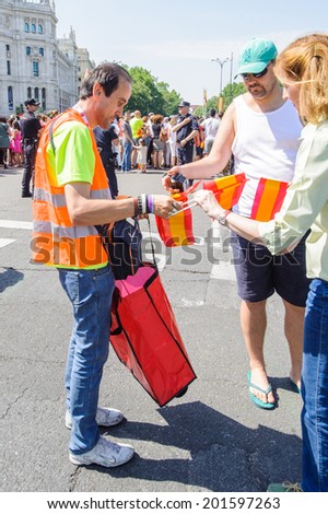 MADRID, SPAIN - JUN 19, 2014: Unidentified Spanish man sells the Spanish national flag in the centre of Madrid during the celebration of the coronation of the New King of Spain Felipe IV