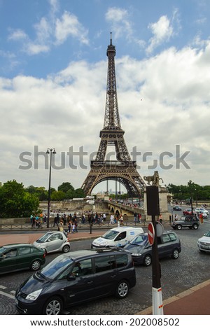PARIS, FRANCE - JUN 17, 2014: Traffic of Paris and the Eiffel Tower in Paris, France. The Eiffel tower was created by Gustave Eiffel and the construction was completed in 1889