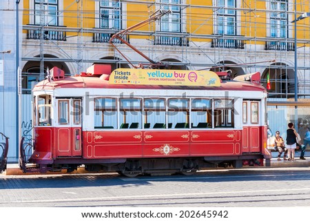 LISBON, PORTUGAL - JUN 20, 2014:  Electric tramway on the Commerce Square (Praca do Comercio) in Lisbon, Portugal. The Square was destoryed by the 1755 Lisbon Earthquake and then it was reconstructed