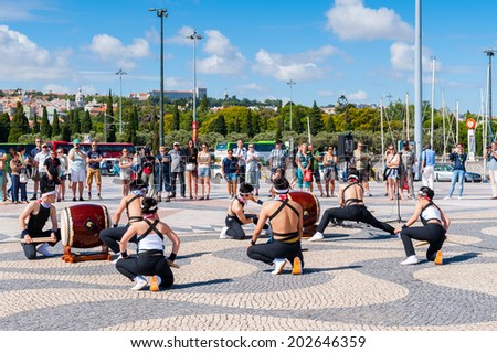 LISBON, PORTUGAL - JUN 20, 2014:  Unidentified musicians make a perfosrmance for the tourists near the Monument to Portuguese Discoveries in Lisbon. It\'s one of the most important landmarks in Lisbon