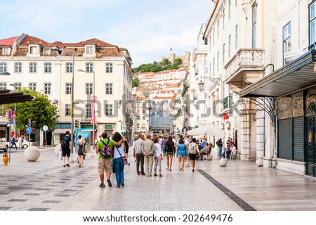 LISBON, PORTUGAL - JUN 20, 2014:  Unidentified people walk in the touristic area in Lisbon, Portugal. Lisbon is the westernmost large city Europe and the seventh-most-visited city in Southern Europe