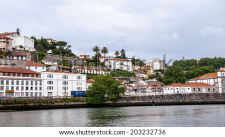 PORTO, PORTUGAL - JUN 21, 2014: Beautiful houses on the coast of the River Douro in Porto, Portugal. View from the River Douro, one of the major rivers of the Iberian Peninsula (2157 m)