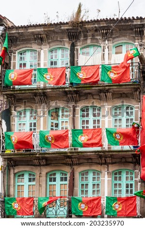 PORTO, PORTUGAL - JUN 21, 2014:  House with multiple Portuguese national flags in Porto. Porto is the second largest city in Portugal and it was called the European Culture Capital in 2001