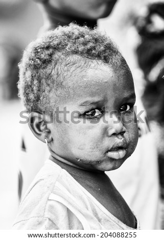 ACCARA, GHANA - MAR 6, 2012: Unidentified Ghanayan boy portrait in black and white. People of Ghana suffer of poverty due to the unstable economical situation