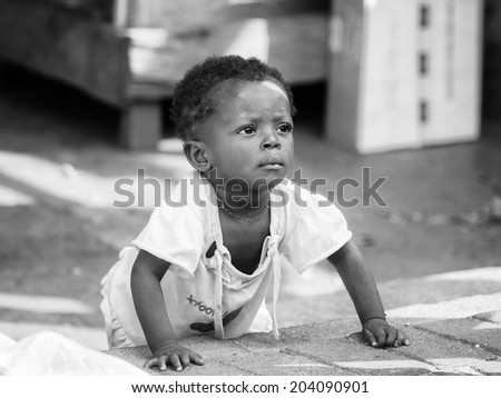 ACCARA, GHANA - MAR 4, 2012: Unidentified Ghanaian little boy portrait in black and white. People of Ghana suffer of poverty due to the unstable economical situation