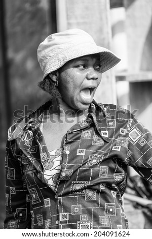 ACCARA, GHANA - MAR 4, 2012: Unidentified Ghanaian screaming woman portrait in black and white. People of Ghana suffer of poverty due to the unstable economical situation