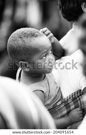 ACCARA, GHANA - MAR 4, 2012: Unidentified Ghanaian boy portrait in black and white. People of Ghana suffer of poverty due to the unstable economical situation