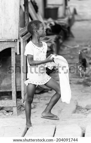 ACCARA, GHANA - MAR 2, 2012: Unidentified Ghanaian girl portrait in black and white. People of Ghana suffer of poverty due to the unstable economical situation