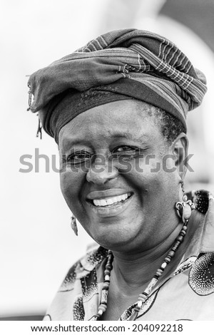 ACCARA, GHANA - MAR 2, 2012: Unidentified Ghanaian smiling woman in black and white. People of Ghana suffer of poverty due to the unstable economical situation