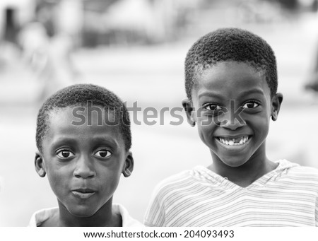 ACCARA, GHANA - MAR 2, 2012: Unidentified Ghanaian two smiling boys in black and white. People of Ghana suffer of poverty due to the unstable economical situation