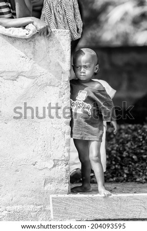 ACCARA, GHANA - MAR 3, 2012: Unidentified Ghanaian little boy portrait in black and white. People of Ghana suffer of poverty due to the unstable economical situation