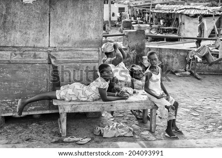 ACCARA, GHANA - MAR 2, 2012: Unidentified Ghanaian children on a bench in black and white. People of Ghana suffer of poverty due to the unstable economical situation