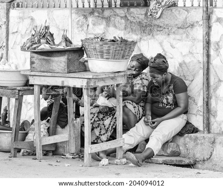ACCARA, GHANA - MAR 2, 2012: Unidentified Ghanaian women work at the market in black and white. People of Ghana suffer of poverty due to the unstable economical situation