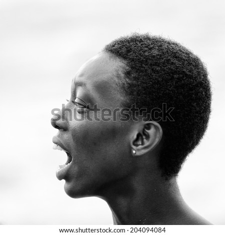 ACCARA, GHANA - MAR 2, 2012: Unidentified Ghanaian woman screams in black and white. People of Ghana suffer of poverty due to the unstable economical situation