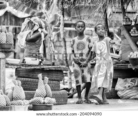 ACCARA, GHANA - MAR 2, 2012: Unidentified Ghanaian girls on a market  in the street  in black and white. Children of Ghana suffer of poverty due to the unstable economical situation
