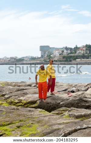 ESTORIL, PORTUGAL - JUNE 22, 2014:Unidentified people on the coast of the Atlantic ocean on The Beach of Tamariz, Estoril, Portugal.Estoril is one of the most expensive resort area in Western Portugal
