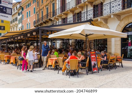 VERONA, ITALY - JUN 26, 2014: Restaurant in the old town of Verona, Italy. City of Verona is a UNESCO World Heritage site
