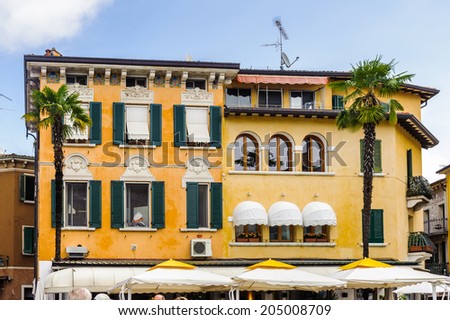 SIRMIONE, ITALY - JUNE 26, 2014: Street restaurant in the Sirmione town, Italy. Sirmione became popular touristic destination on the Lake garda, the largest lake in Italy