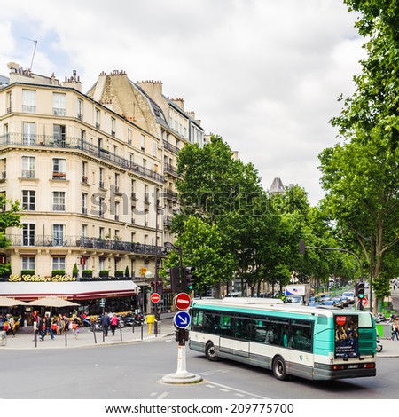 PARIS, FRANCE - JUN 17, 2014: Achitecture and traffic on the street in Paris, France. Paris is one of the most popular touristic destinations in the world