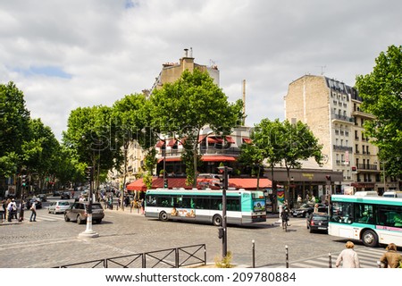 PARIS, FRANCE - JUN 17, 2014: Achitecture and traffic on the street in Paris, France. Paris is one of the most popular touristic destinations in the world