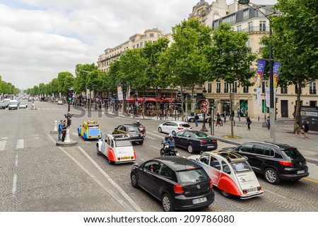 PARIS, FRANCE - JUN 17, 2014: Avenue des Champs-Elysees in Paris, France. Champs-Elysees is one of the world\'s most famous streets, and is one of the most expensive strips of real estate in the world