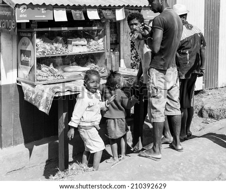ANTANANARIVO, MADAGASCAR - JULY 1, 2011: Unidentified Madagascar people buy something at the market. People in Madagascar suffer of poverty due to slow development of the country