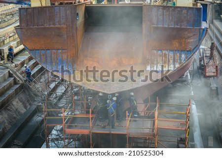 CAPE TOWN, SOUTH AFRICA - FEB 22, 2013: Unidentified workers work on the ship in Cape Town, South Africa. Cape town is the most popular international touristic destination in Africa