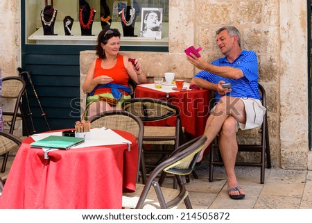 DUBROVNIK, CROATIA - AUG 21, 2014: Unidentified tourists in a small restaurant of the Old town of Dubrovnik, Croatia. Dubrovnik is a UNESCO World Heritage site