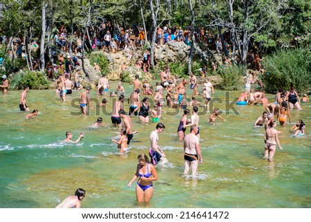 KRKA NATIONAL PARK, CROATIA - AUG 26, 2014: Unidentified tourist swim in the Krka River in the Krka National Park in Croatia. It is one of the National Parks in Croatia with an area of 109 km2