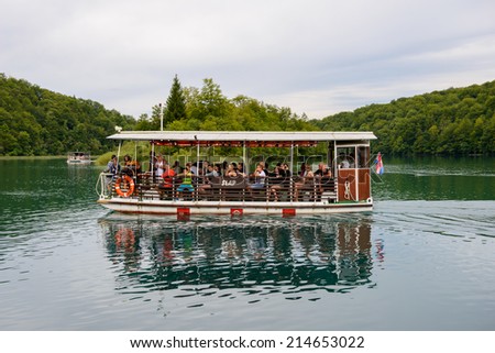 PLITVICE LAKE NATIONAL PARK, CROATIA - AUG 19, 2014: Unidentified people    on board of a tourist boat in the Plitvice Lakes National Park, which is a UNESCO World Heritage site