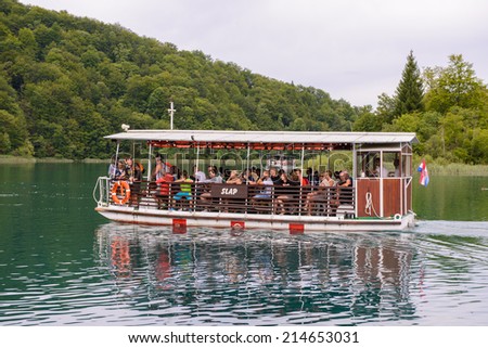 PLITVICE LAKE NATIONAL PARK, CROATIA - AUG 19, 2014: Unidentified people    on board of a tourist boat in the Plitvice Lakes National Park, which is a UNESCO World Heritage site