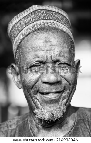 PORTO-NOVO, BENIN - MAR 8, 2012: Portrait of Unidentified Beninese old man smiling in a typical hat. People of Benin suffer of poverty due to the difficult economic situation.