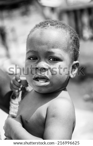 PORTO-NOVO, BENIN - MAR 8, 2012: Unidentified Beninese little boy cries. People of Benin suffer of poverty due to the difficult economic situation.