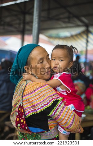 BAC HA, VIETNAM - SEP 21, 2014: Unidentified woman and her little daughter at the Bac Ha Market, a large Sunday market with people wearing beautiful colored minorities costumes
